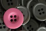 Close-up of a pink button with gray buttons