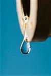 Close-up of a water drop dripping from a faucet