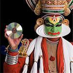 Portrait of a Kathakali dance performer holding a CD