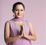 Portrait of a mid adult woman in salwar kameez with her folded hands