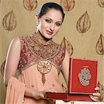 Portrait of a mid adult woman in salwar kameez and holding a jewelry box
