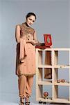 Portrait of a mid adult woman in salwar kameez and holding a jewelry box