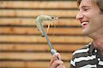 Man holding a shrimp with gripper