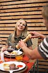 Woman smiling at man while having a dinner