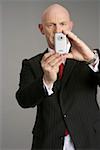 Businessman photographing with a mobile phone