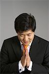 Asian businessman greeting with palms together