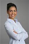 Businesswoman with crossed arms smiling at camera