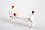 Figurines of doctors carrying a stretcher