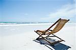 Wooden deckchair on beach