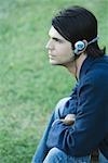 Man listening to headphones outdoors