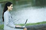 Woman using laZSop, lake in background