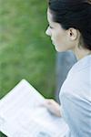 Businesswoman holding newspaper