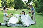 Young campers setting up tent