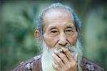 Elderly man smoking cigarette