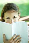 Woman looking over book