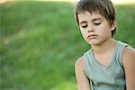 Little boy outdoors, looking down