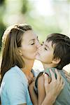 Mother and son, woman kissing boy on cheek