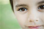 Little boy looking at camera, cropped view of face, close-up