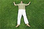 Man lying on grass, full length