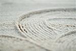 Pattern traced into sand, full frame, extreme close-up