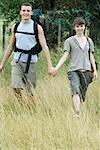 Young couple going for hike, holding hands