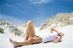 Young woman lying on beach