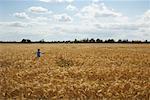 Girl Running through Grain Field