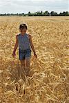 Girl Walking through Grain Field