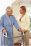 Senior Woman Receiving Assistance with Using Walker