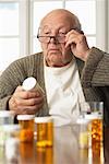 Senior Man Looking at Pill Bottle Label