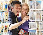 Couple Looking at Postcards