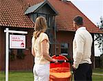 Couple Standing in Front of House