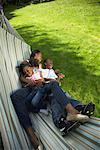 Mother with Son and Daughter in Hammock