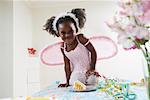 Girl in Costume Eating Cake