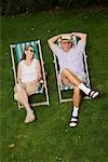 Couple Sitting in Lawn Chairs