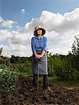 Woman Standing in Garden with Pitchfork