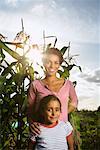 Portrait of Woman and Child in Front of Corn Plants