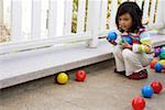 Girl playing with balls, side view