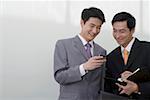 Businessmen with mobile phone, smiling