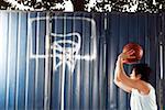 Young man throwing basketball