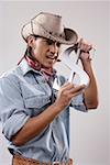 Close-up of a young man holding dollar sign