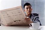 Young man holding newspaper