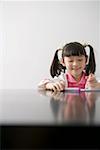 Girl drawing at table