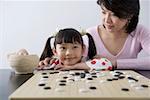 Mother and daughter playing Chinese chess