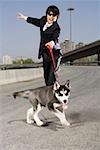 Man holding dog on an overpass