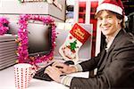 Portrait of a businessman typing on keyboard and smiling