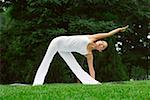 Young woman in white posing on lawn