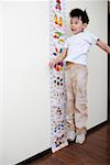 Boy jumping by tape measure