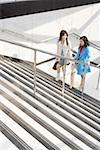 Young women at staircase in shopping mall