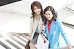 Young women at staircase in shopping mall